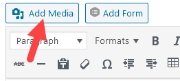 WordPress editor toolbar with a red arrow pointing to the Add Media button at the top left
